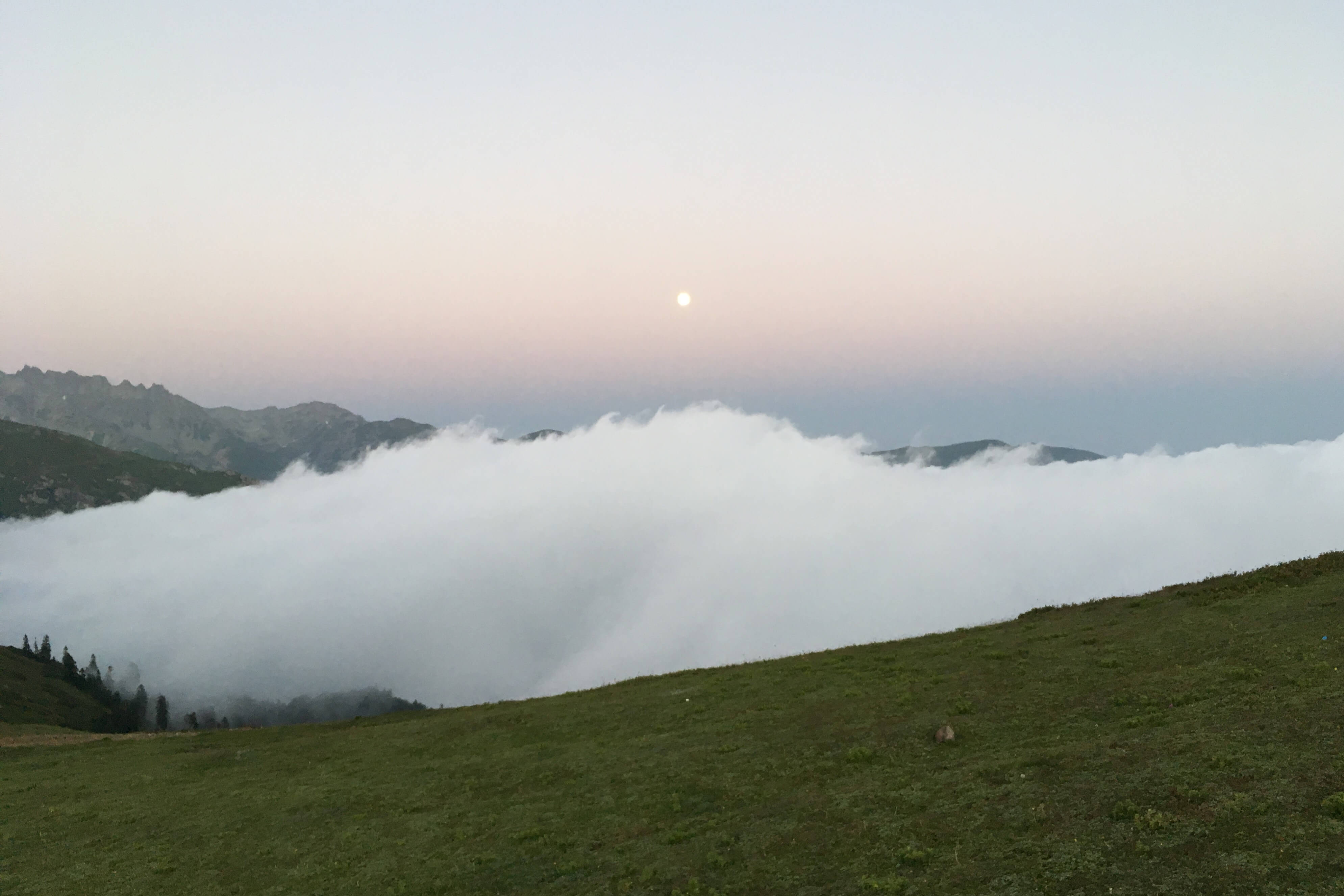 mountains separated by a valley of cloud